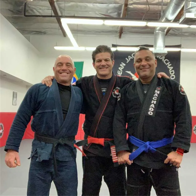 Joe Rogan training BJJ in a black gi