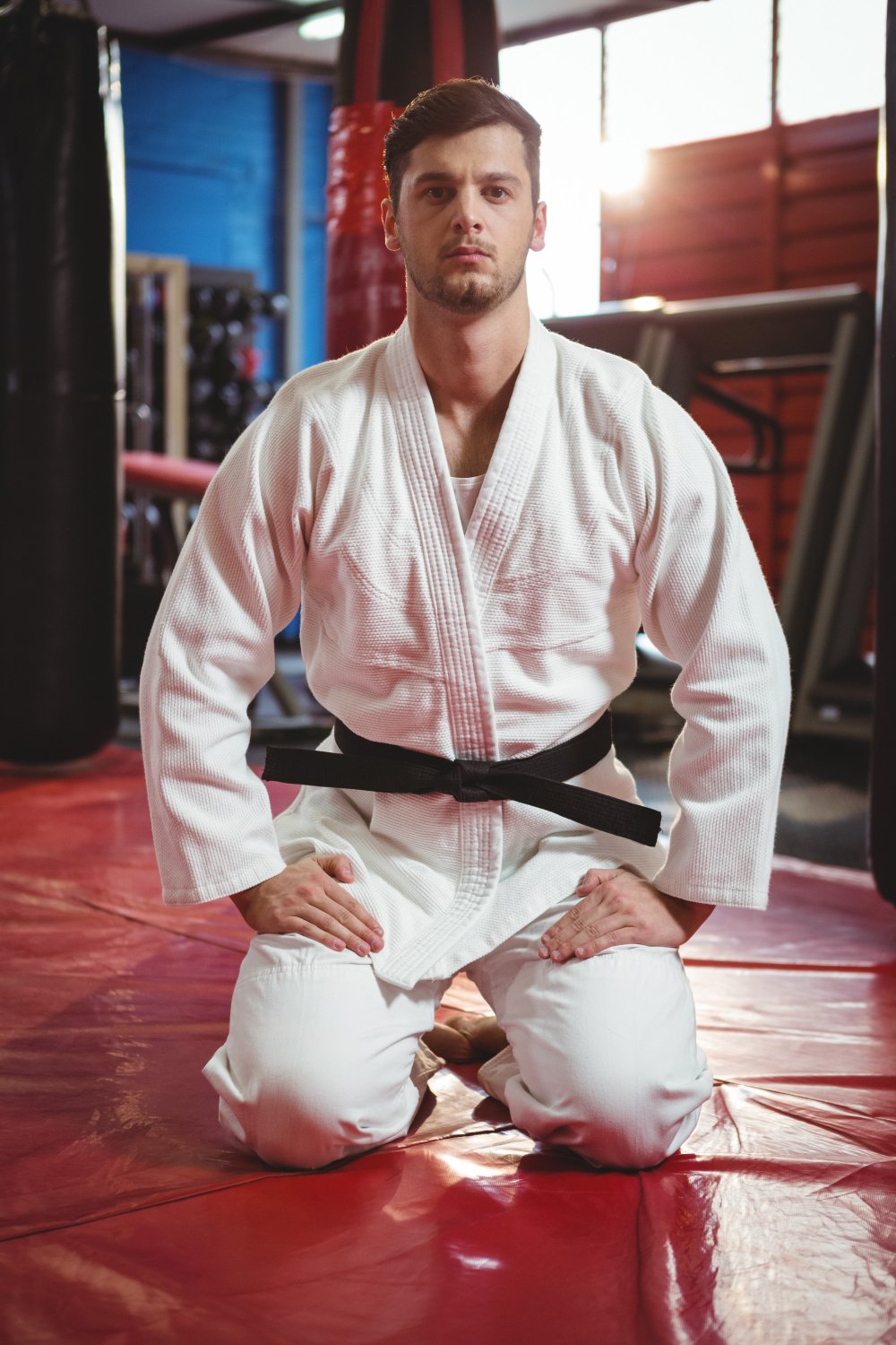 Judoka wearing a black belt during training